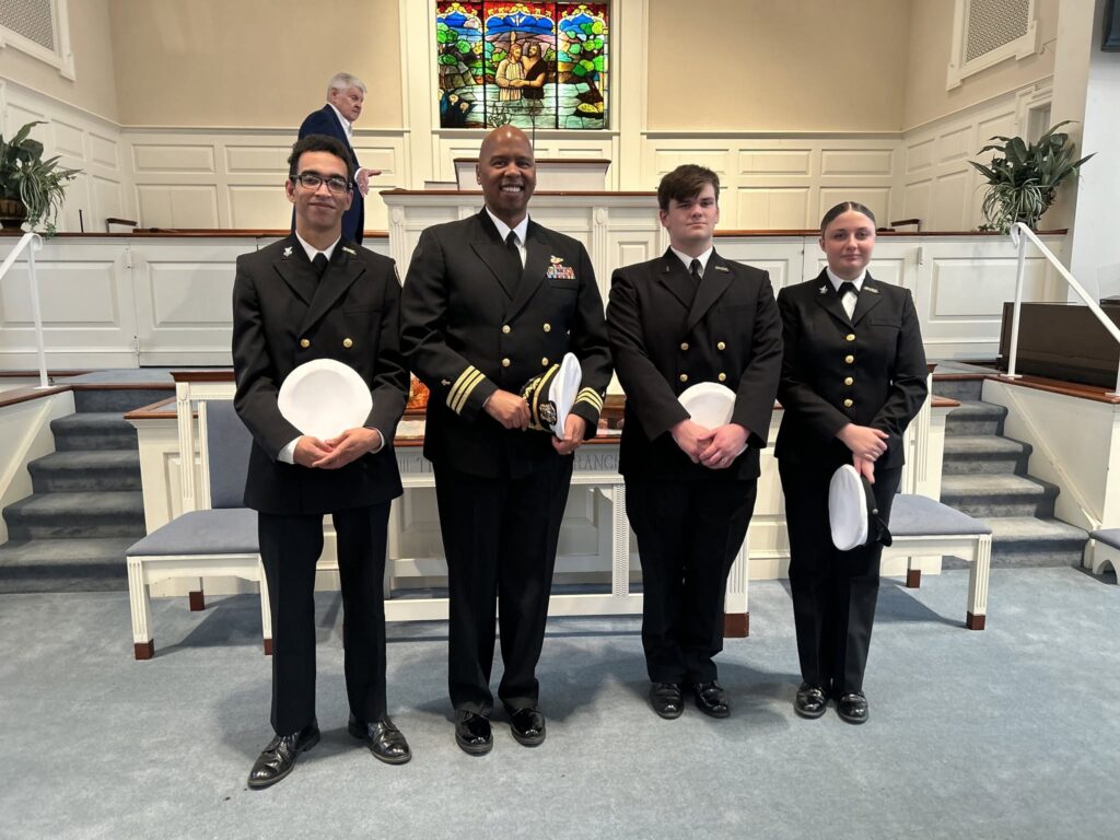 Sailors in dress uniform recognized at Sunday worship