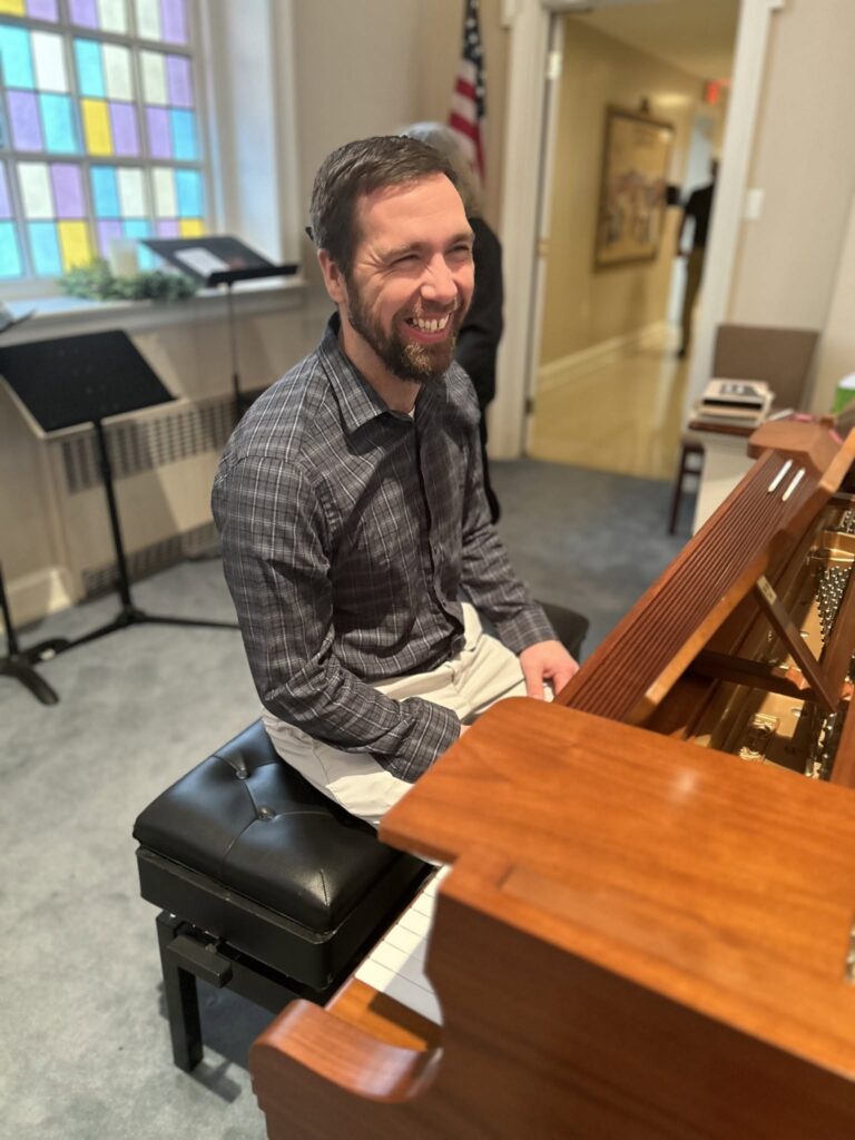 Pianist smiling at the piano at Four Mile Creek Baptist Church