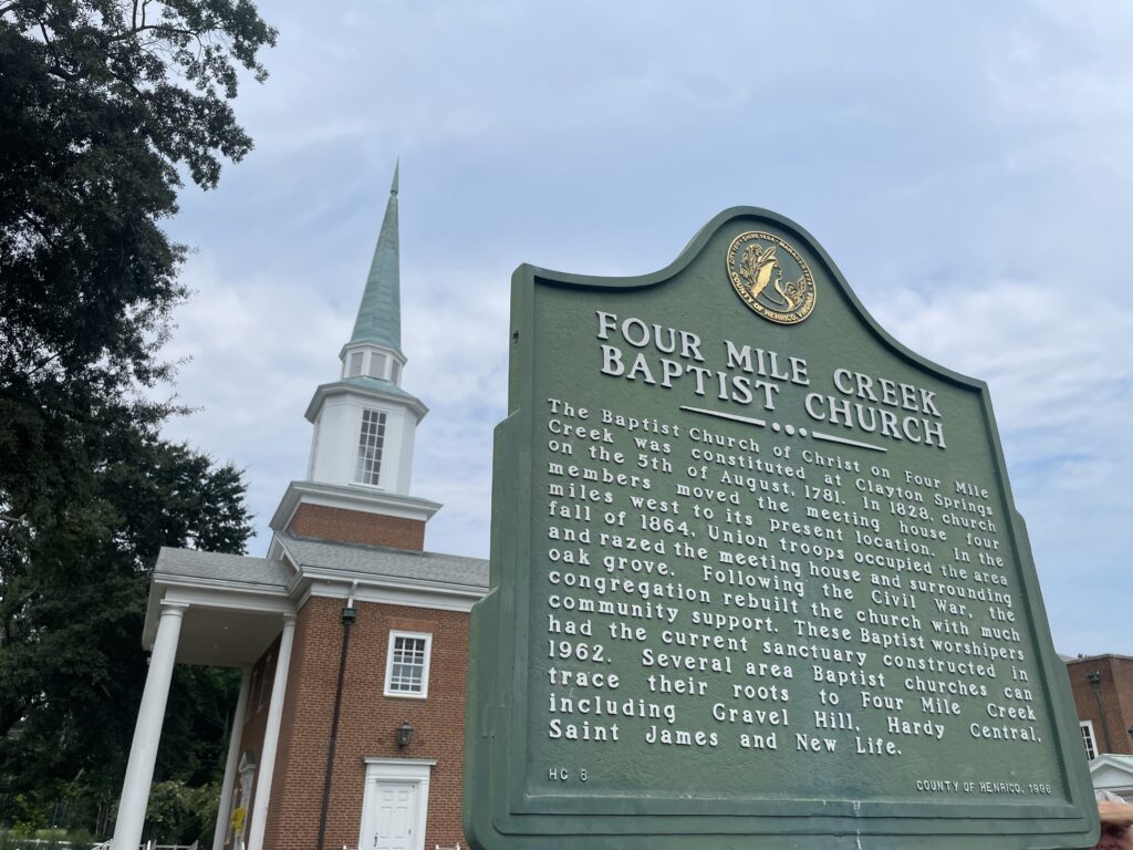 Henrico County historical marker for Four Mile Creek Baptist Church, with the steeple in the background
