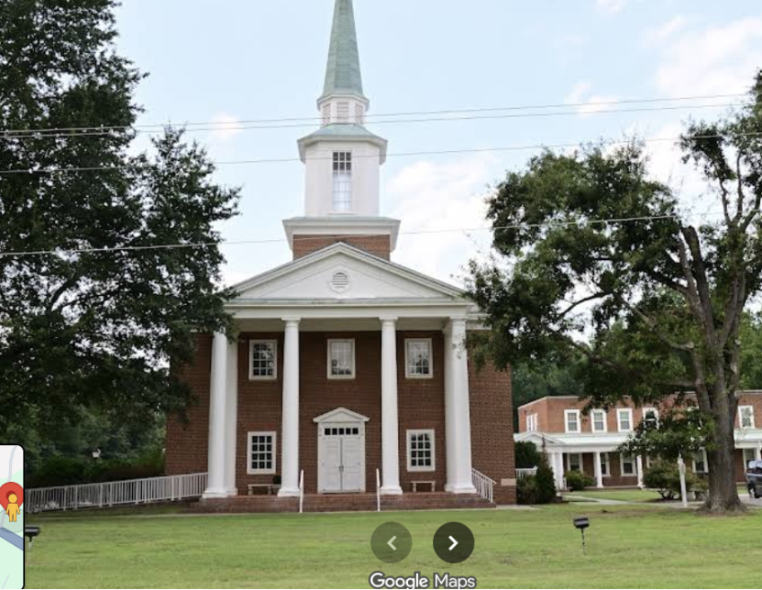 Front portico of Four Mile Creek Baptist Church, historic white columns and steeple