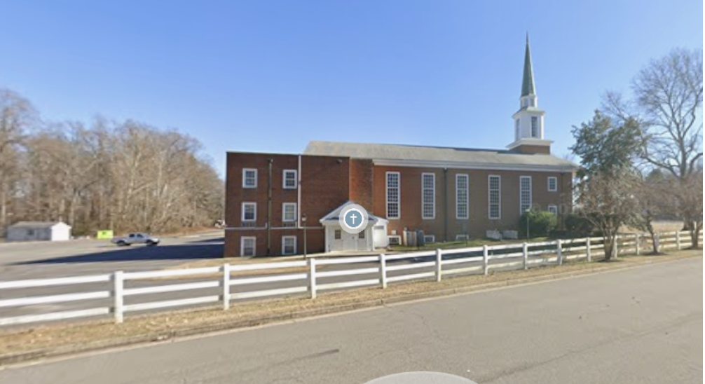 Four Mile Creek Baptist Church exterior seen from New Market Road, white fence and steeple